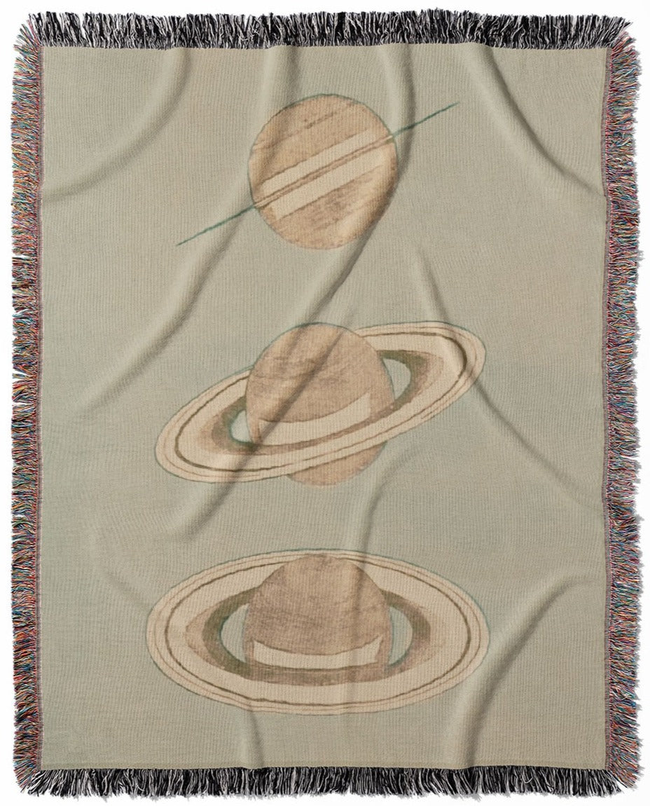 The Rings of Saturn woven throw blanket, made of 100% cotton, featuring a soft and cozy texture with a science drawing theme for home decor.