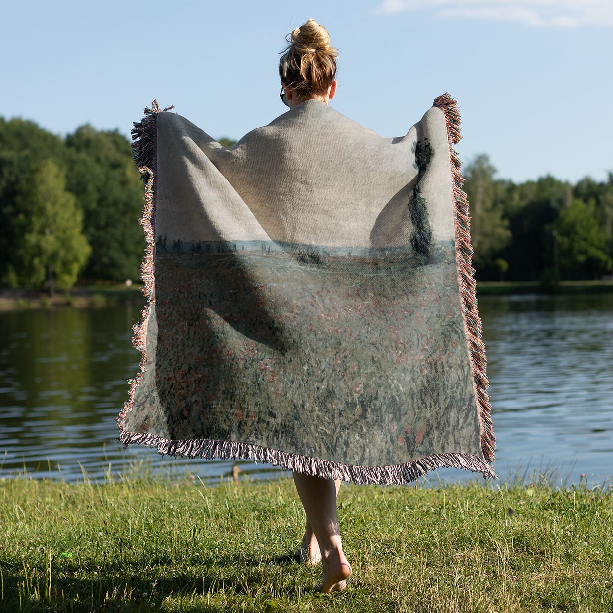 Tranquil Landscape Woven Throw Blanket Held on a Woman's Back Outside