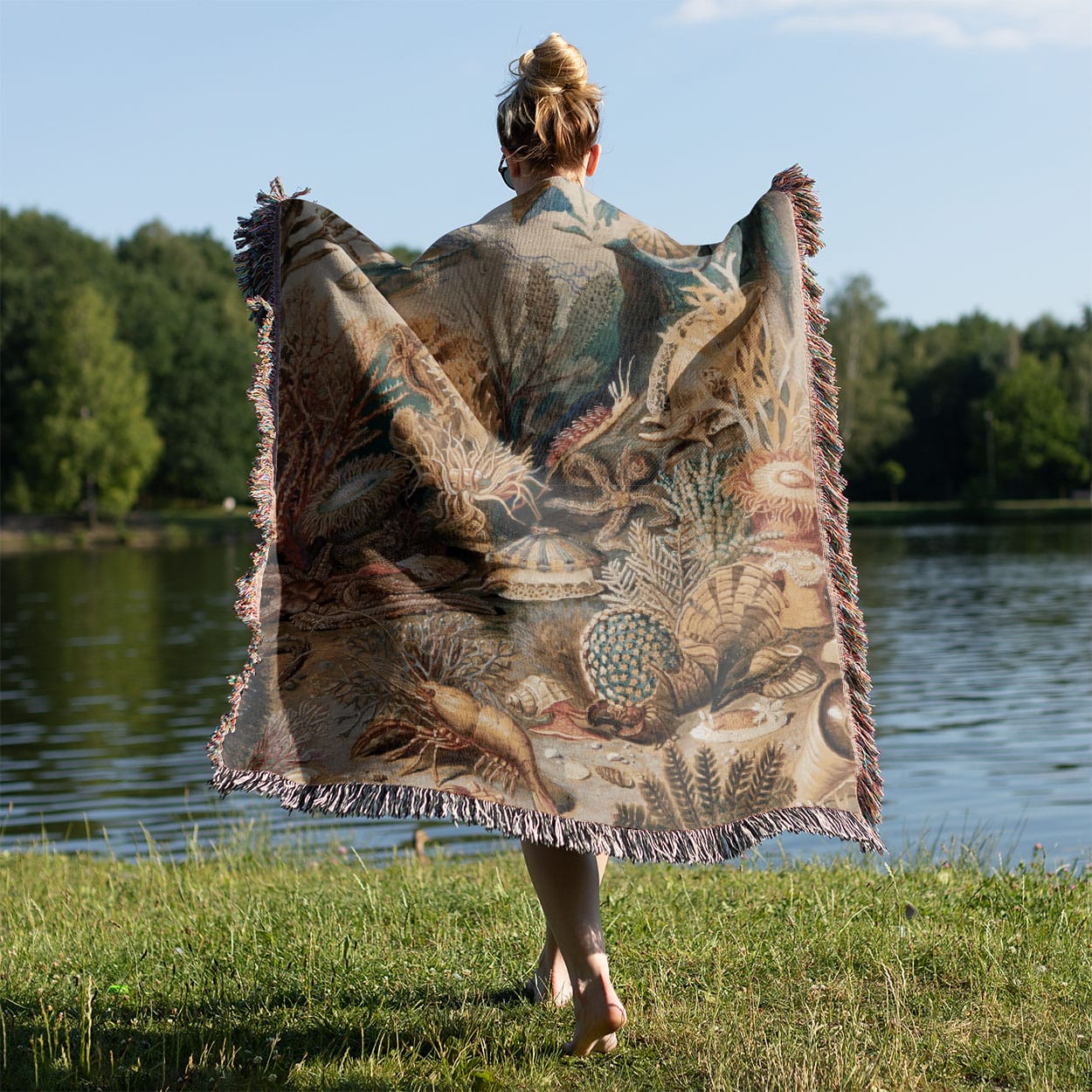 Under the Sea Woven Throw Blanket Held on a Woman's Back Outside