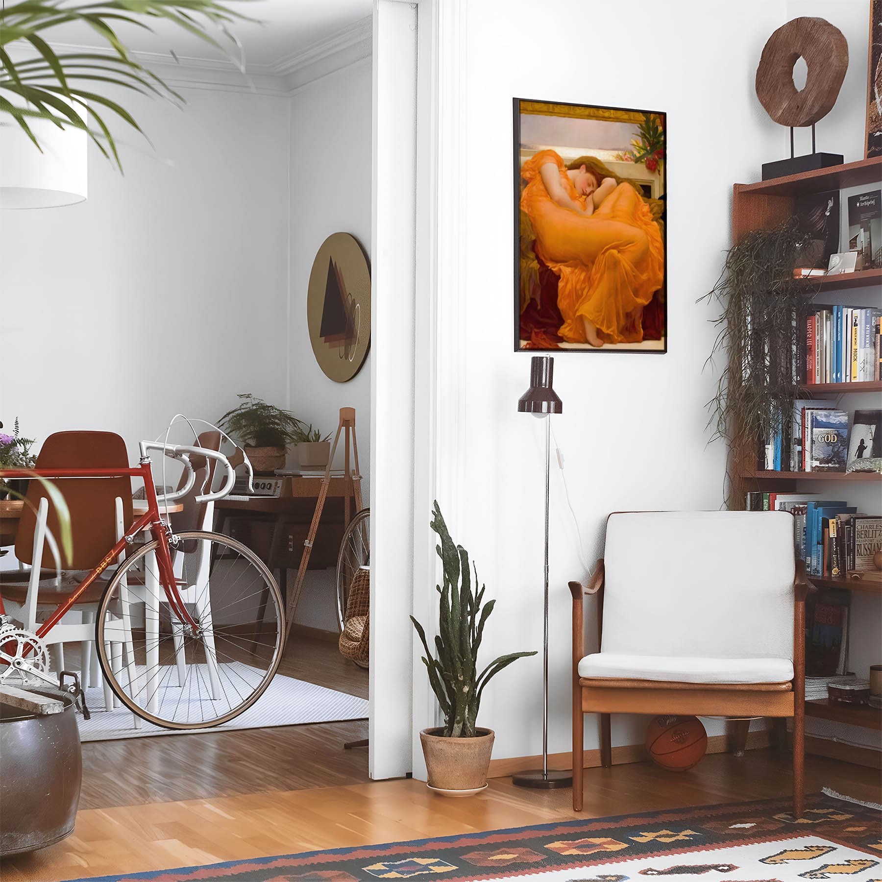 Eclectic living room with a road bike, bookshelf and house plants that features framed artwork of a Woman Sleeping in a Bright Orange Dress above a chair and lamp