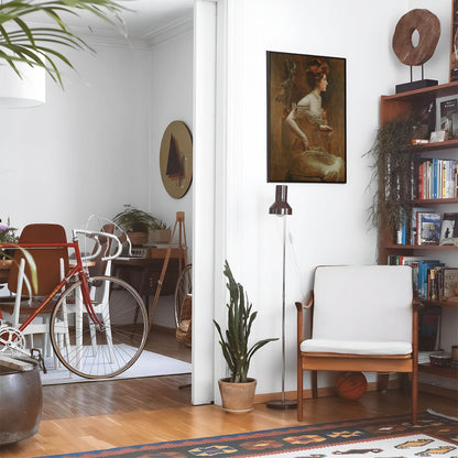 Eclectic living room with a road bike, bookshelf and house plants that features framed artwork of a Woman in Tan Hues above a chair and lamp