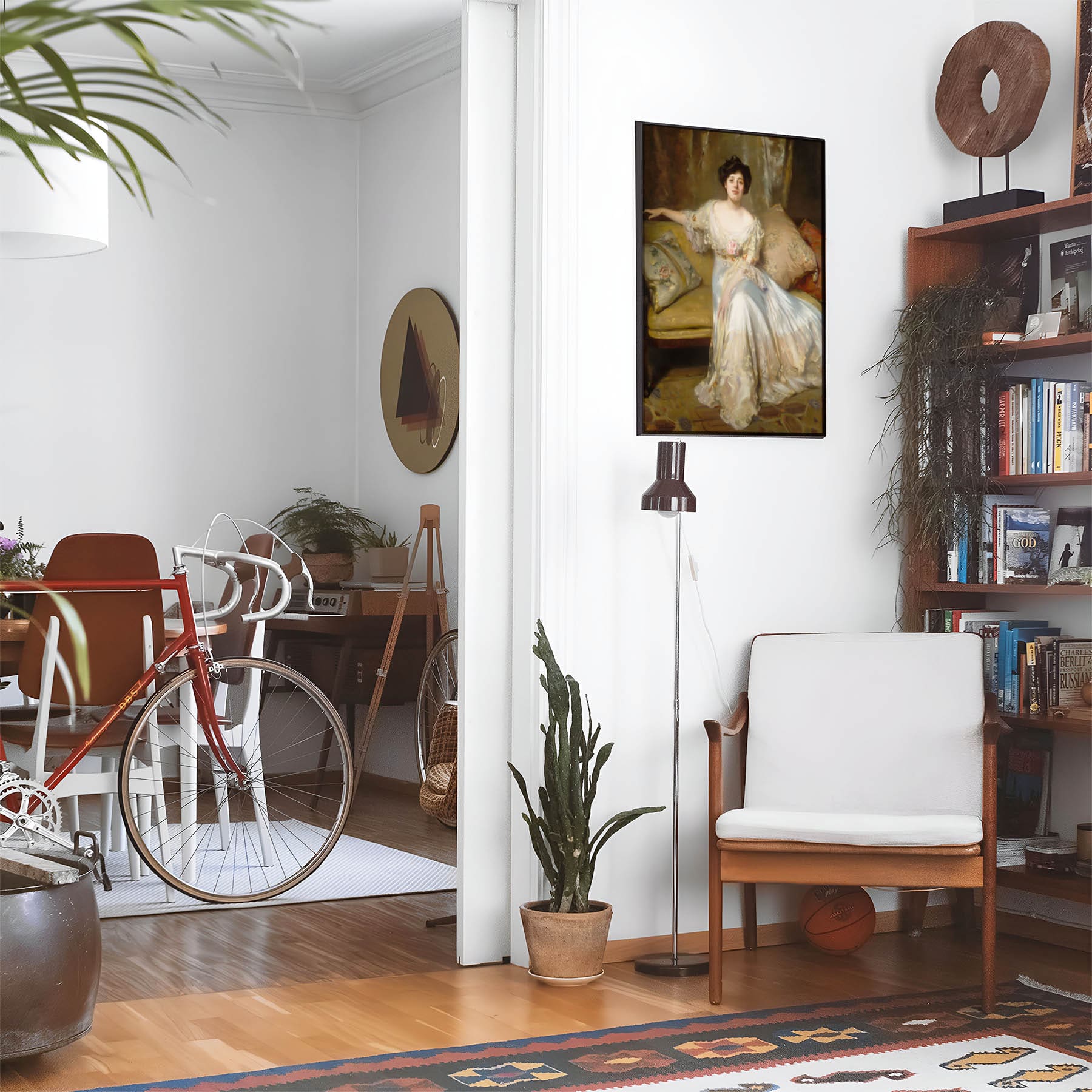 Eclectic living room with a road bike, bookshelf and house plants that features framed artwork of a Woman in a White Dress above a chair and lamp