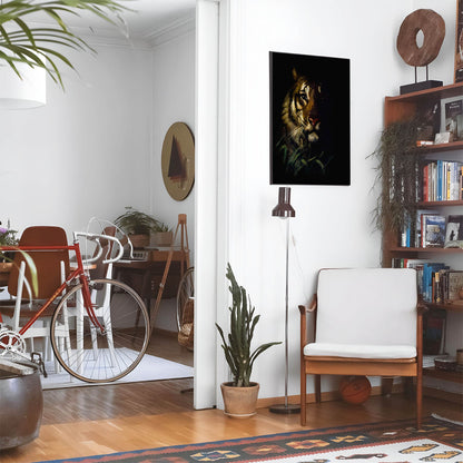 Eclectic living room with a road bike, bookshelf and house plants that features framed artwork of a Dark Tiger above a chair and lamp