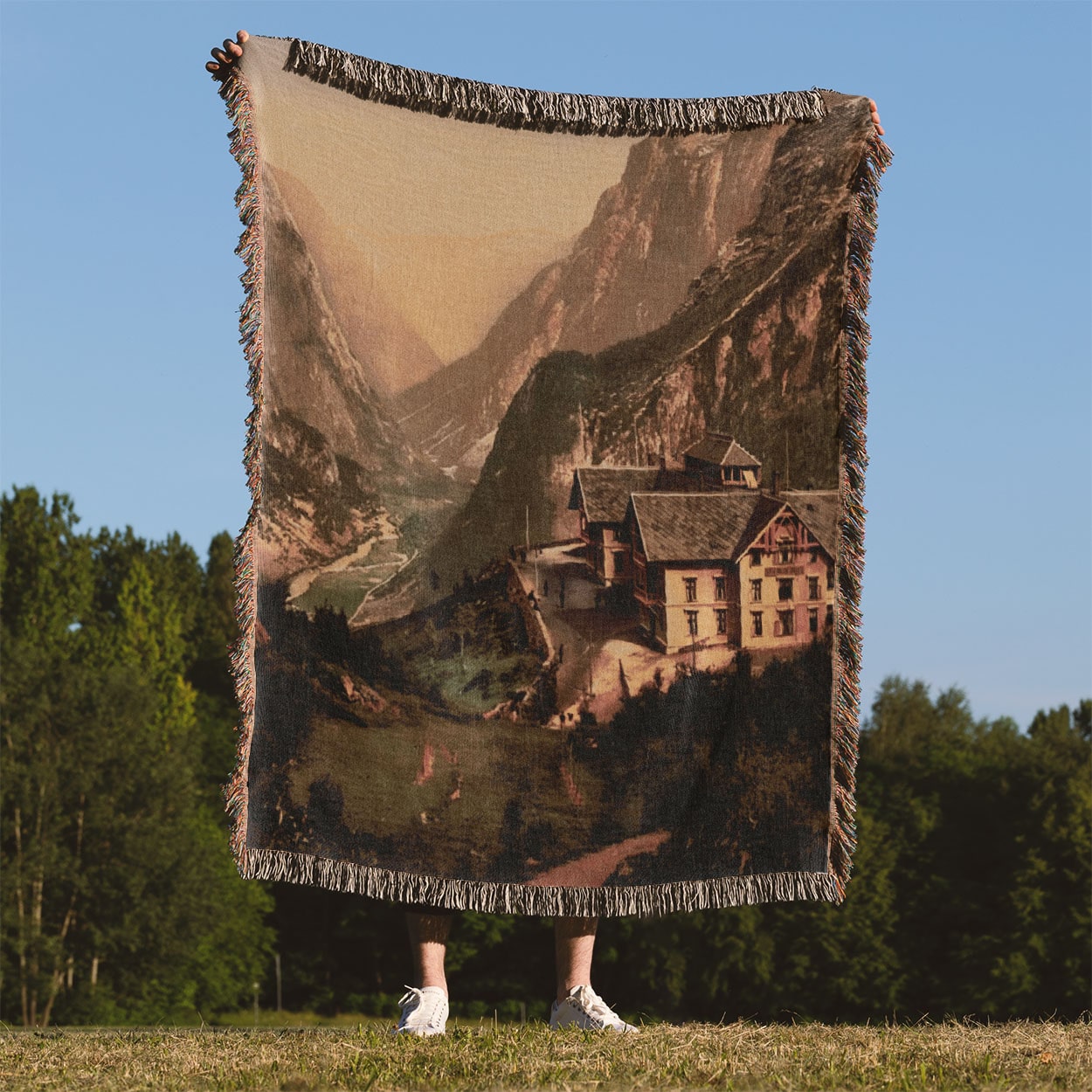 Vintage Mountain Hotel Woven Blanket Held Up Outside