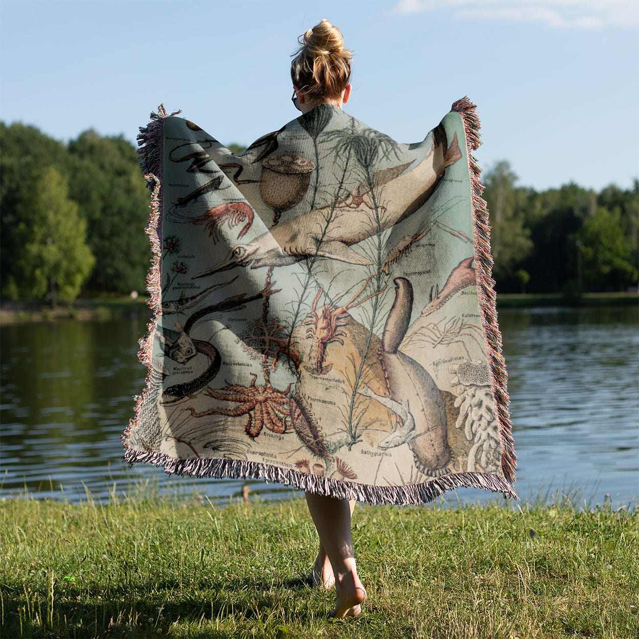 Vintage Ocean Woven Blanket Held on a Woman's Back Outside