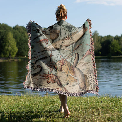 Vintage Ocean Woven Blanket Held on a Woman's Back Outside