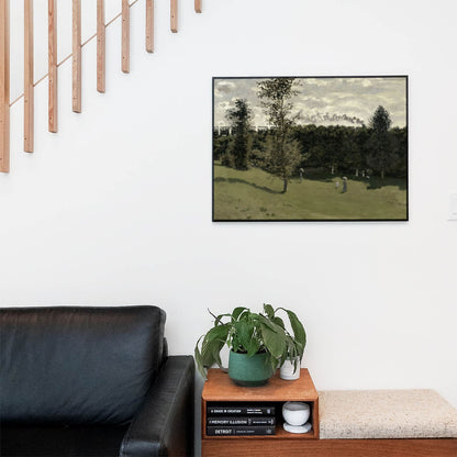 Living space with a black leather couch and table with a plant and books below a staircase featuring a framed picture of Spring