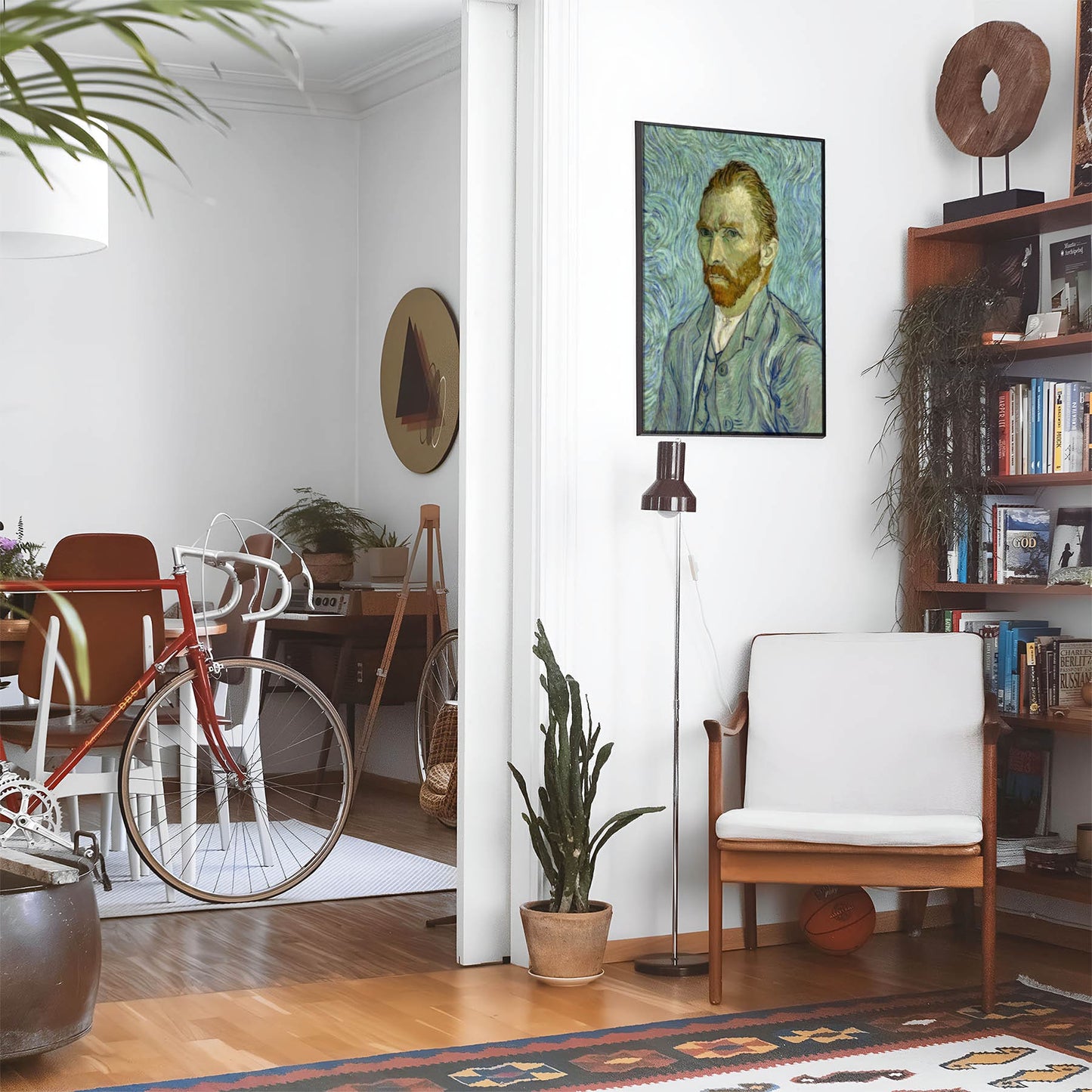 Eclectic living room with a road bike, bookshelf and house plants that features framed artwork of a Colorful and Trippy van Gogh above a chair and lamp
