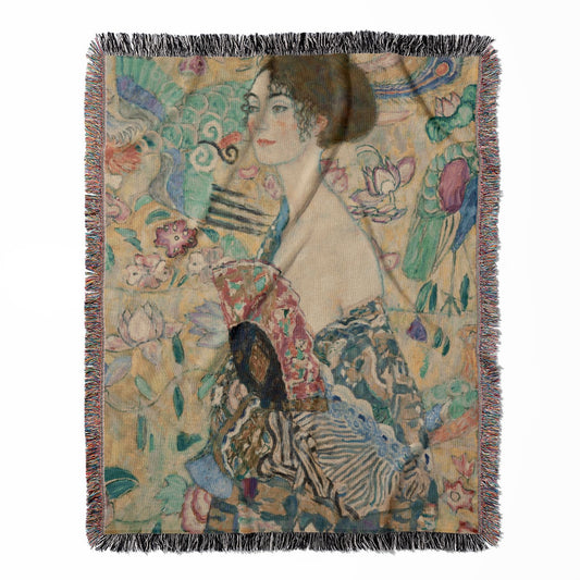 Whimsical woven throw blanket, made with 100% cotton, providing a soft and cozy texture with a lady with fan design for home decor.