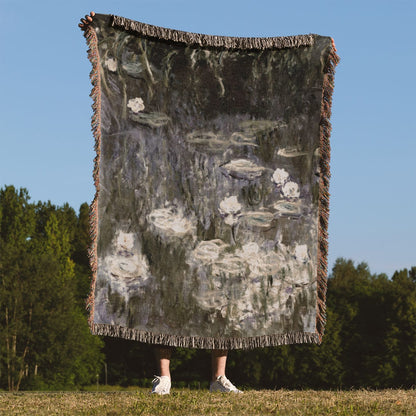 White Lilies on a Pond Woven Blanket Held Up Outside