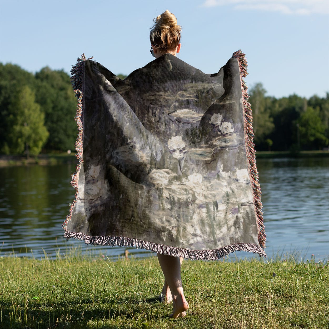 White Lilies on a Pond Woven Blanket Held on a Woman's Back Outside