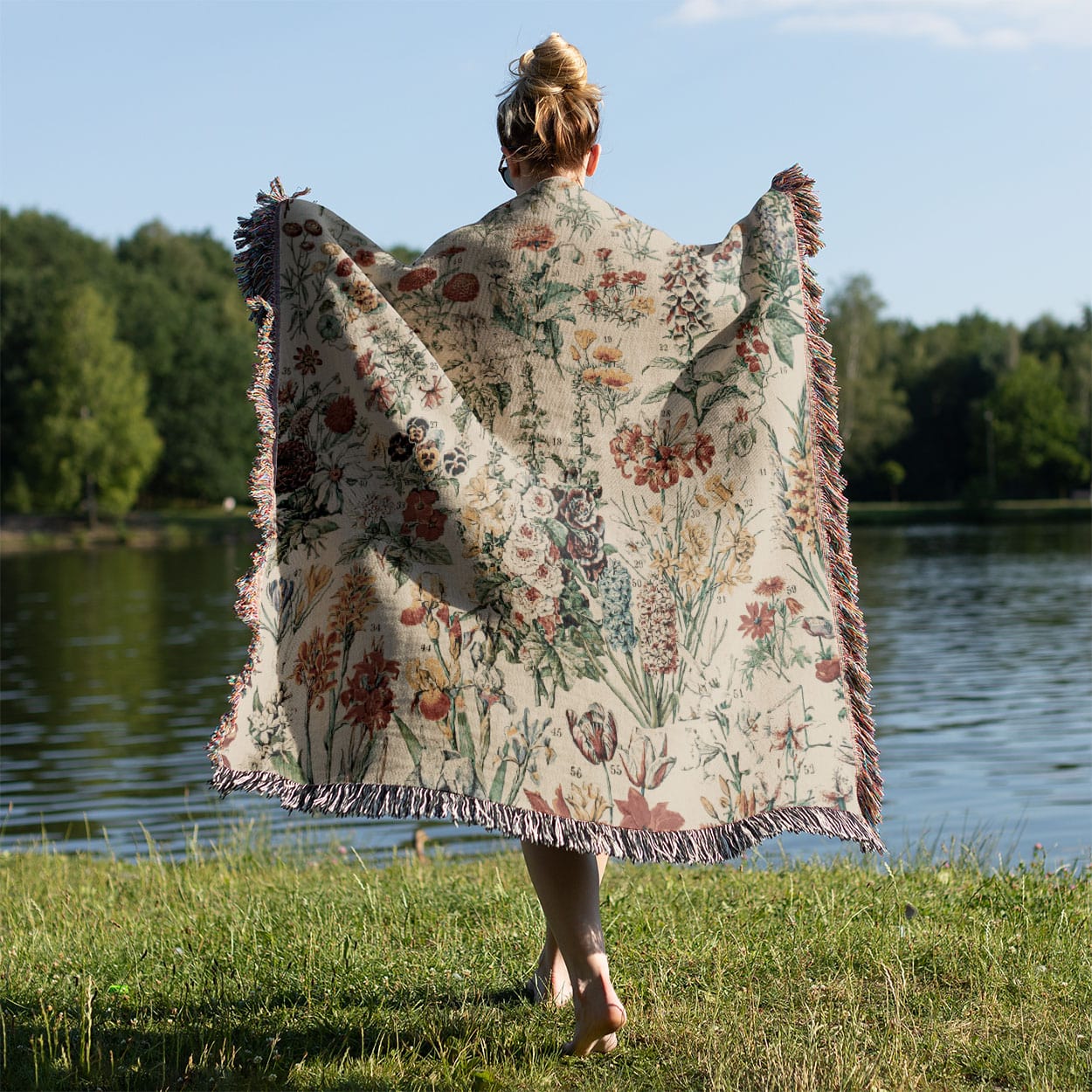 Wildflower Woven Blanket Held on a Woman's Back Outside