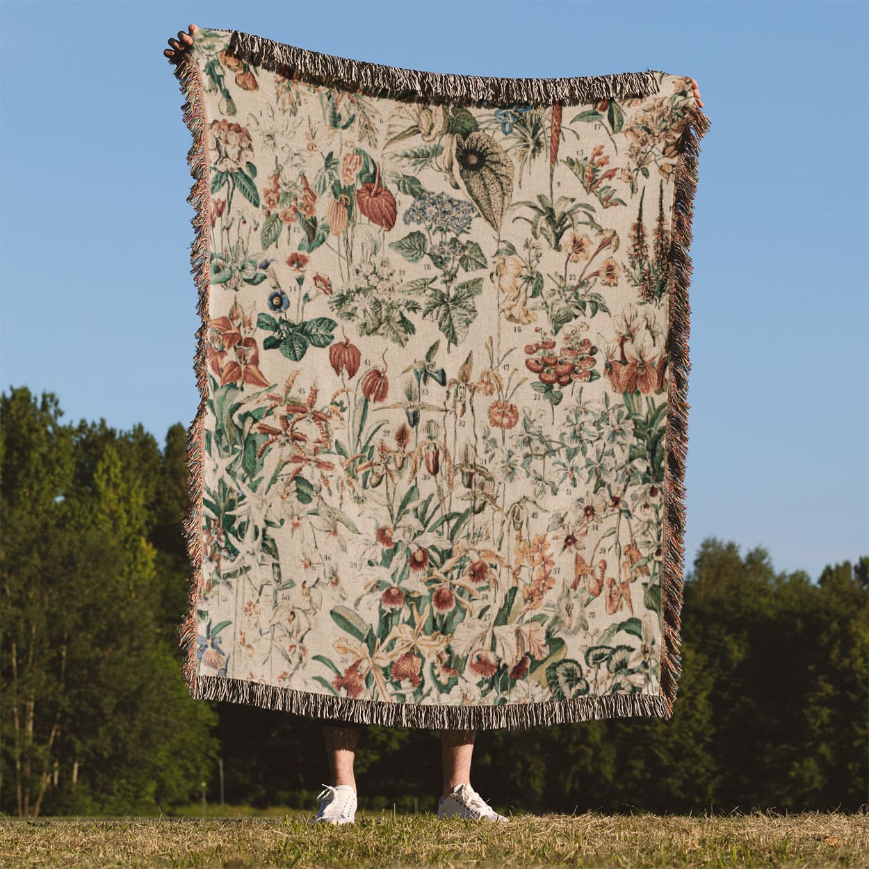 Wildflower and Plants Woven Blanket Held Up Outside