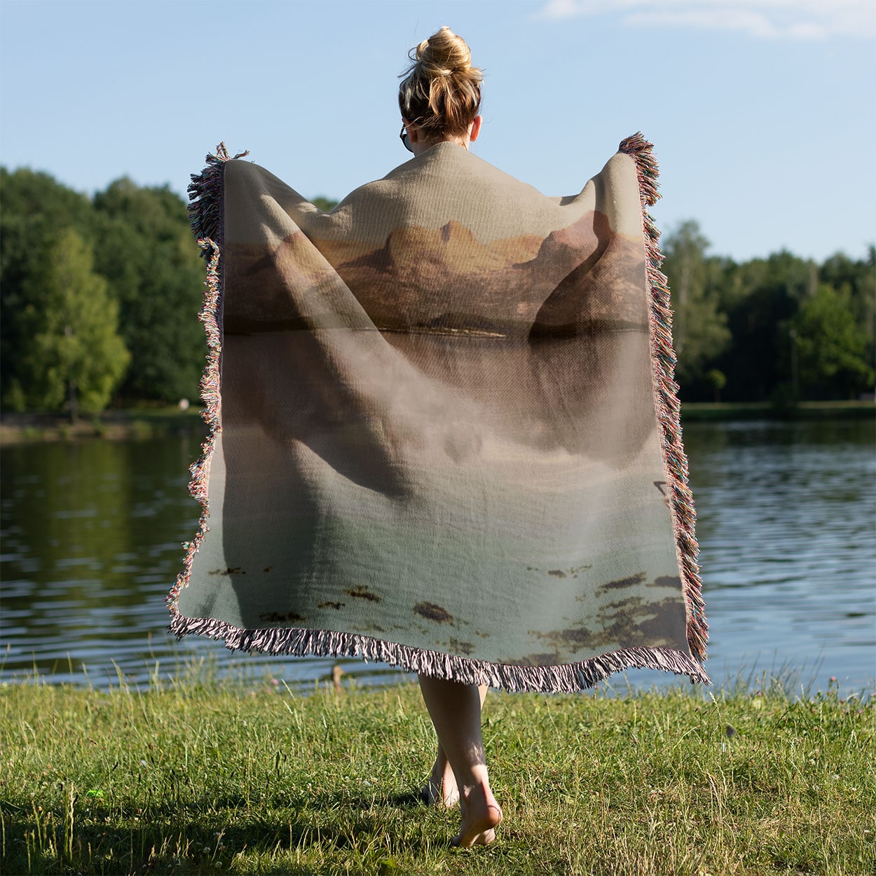 Winter Landscape Woven Throw Blanket Held on a Woman's Back Outside