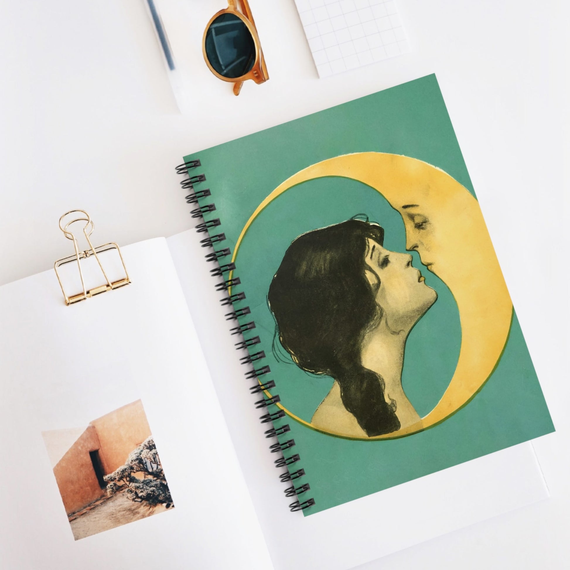Woman Kissing the Moon Spiral Notebook Displayed on Desk