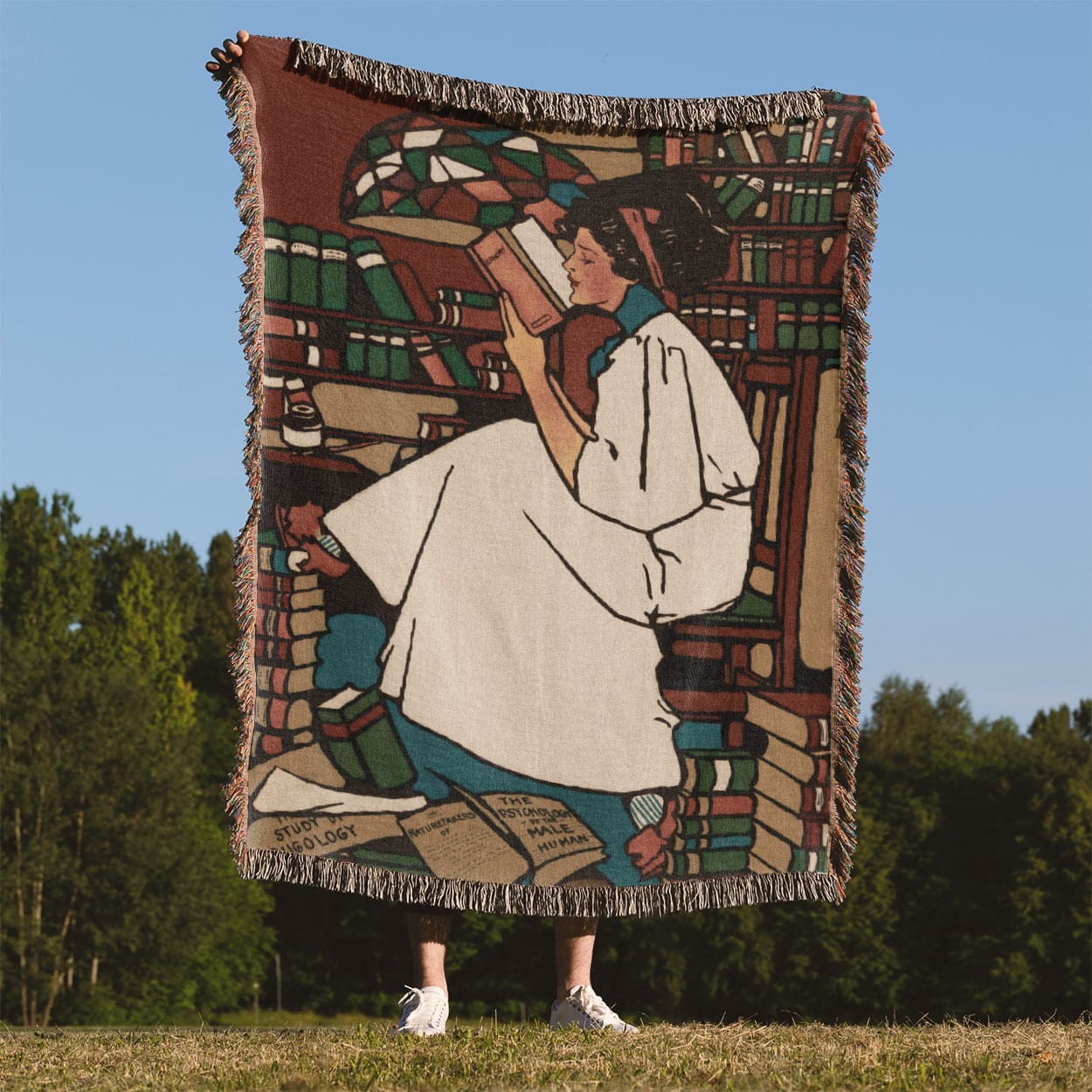 Woman Reading Woven Blanket Held Up Outside