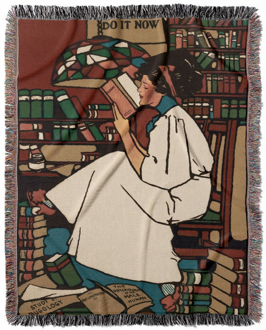 Woman Reading woven throw blanket, made of 100% cotton, delivering a soft and cozy texture with a reading on a stack of books theme for home decor.