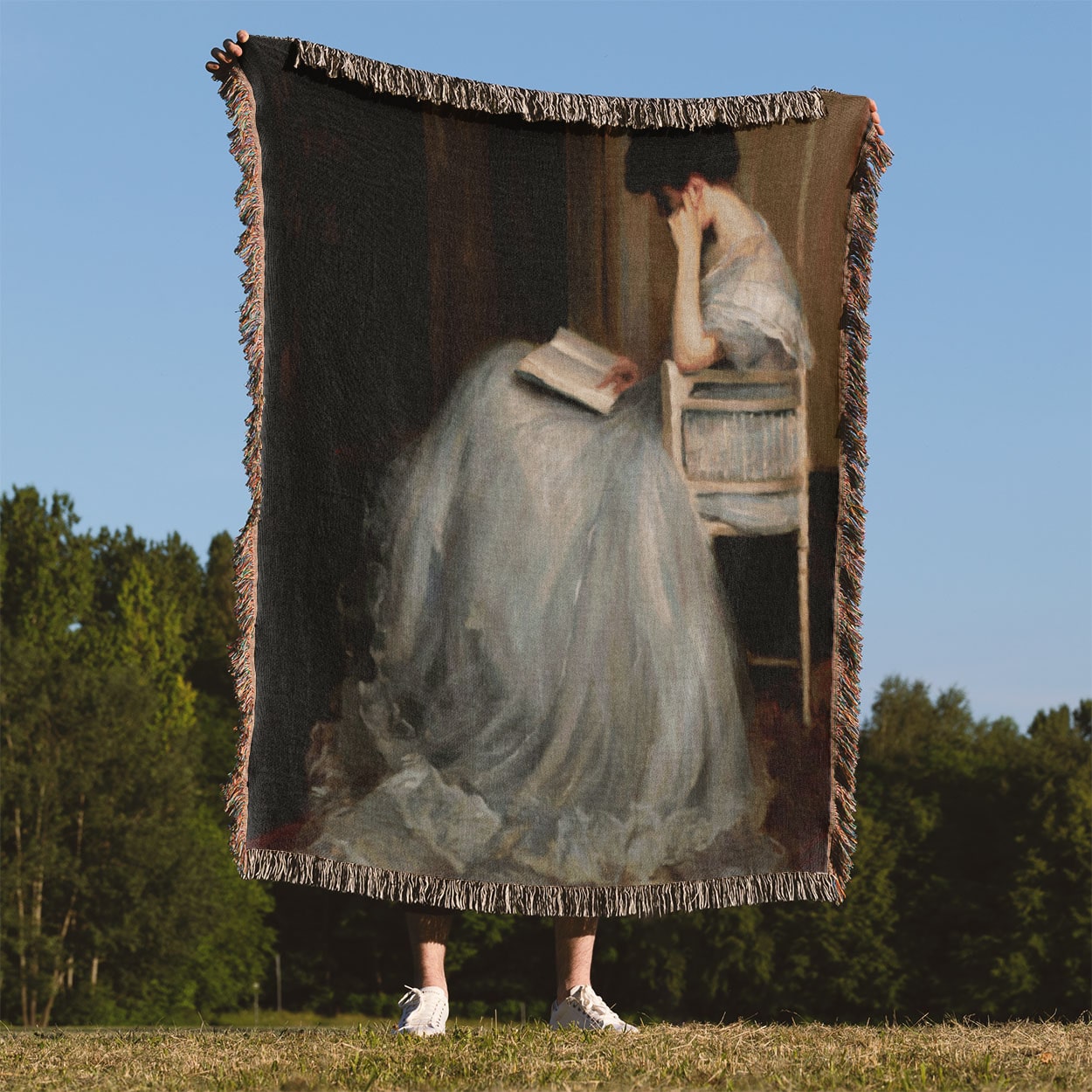 Woman Reading Woven Blanket Held Up Outside