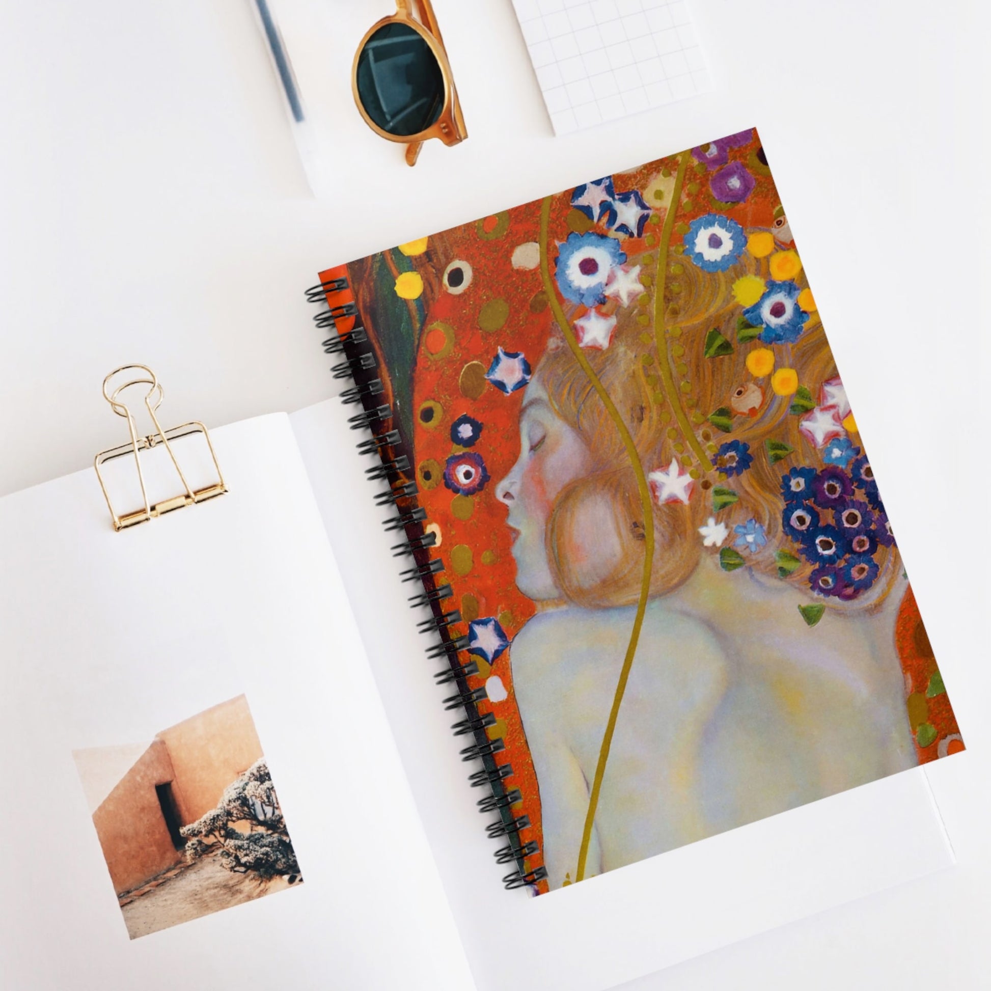 Woman with Flower Hair Spiral Notebook Displayed on Desk